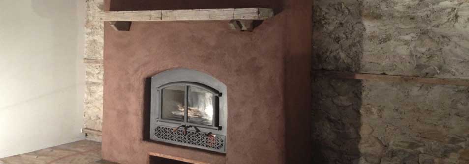 Earthen fireplace surround and natural stone wall